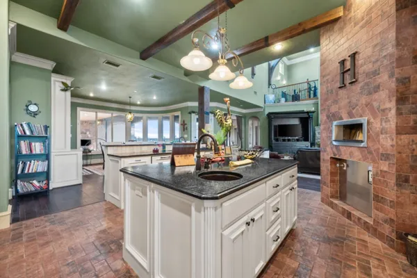 a kitchen with stainless steel appliances granite countertop a sink and cabinets