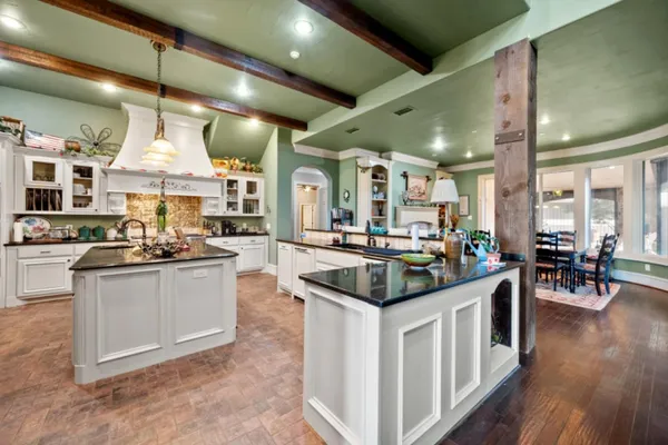 a kitchen with stainless steel appliances granite countertop a stove and a sink