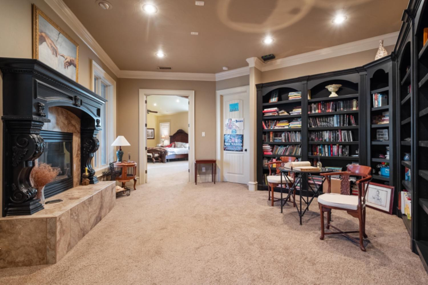 5631 Woodrow Road Lubbock, TX 79424 - Photo 25 of 50 a living room with furniture a bookshelf and a large window