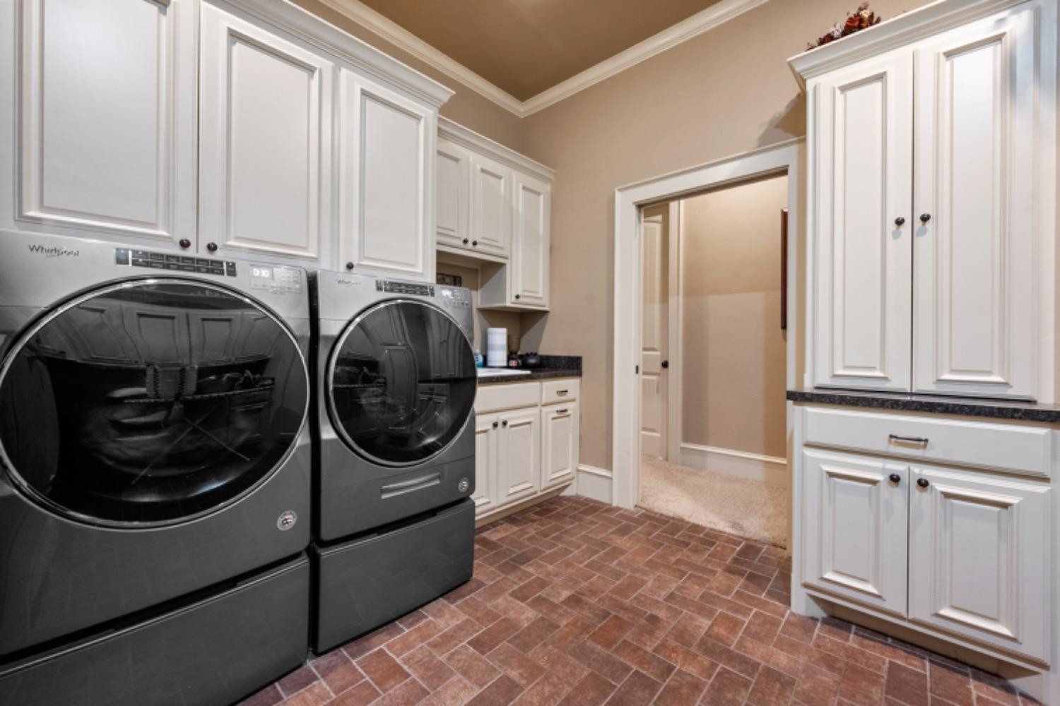 5631 Woodrow Road Lubbock, TX 79424 - Photo 36 of 50 a utility room with sink dryer and washer