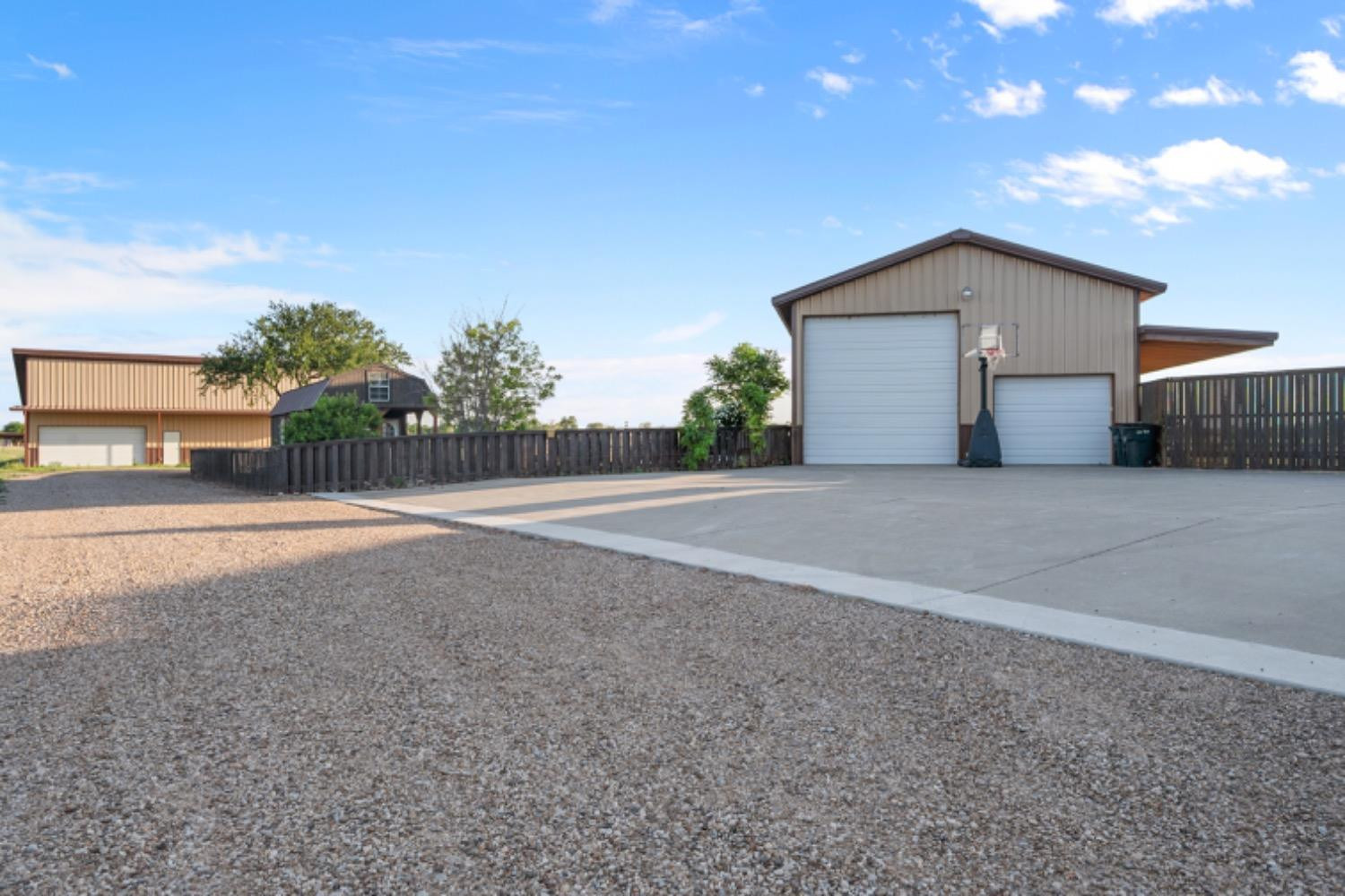 5631 Woodrow Road Lubbock, TX 79424 - Photo 47 of 50 a view of a house with backyard and bushes