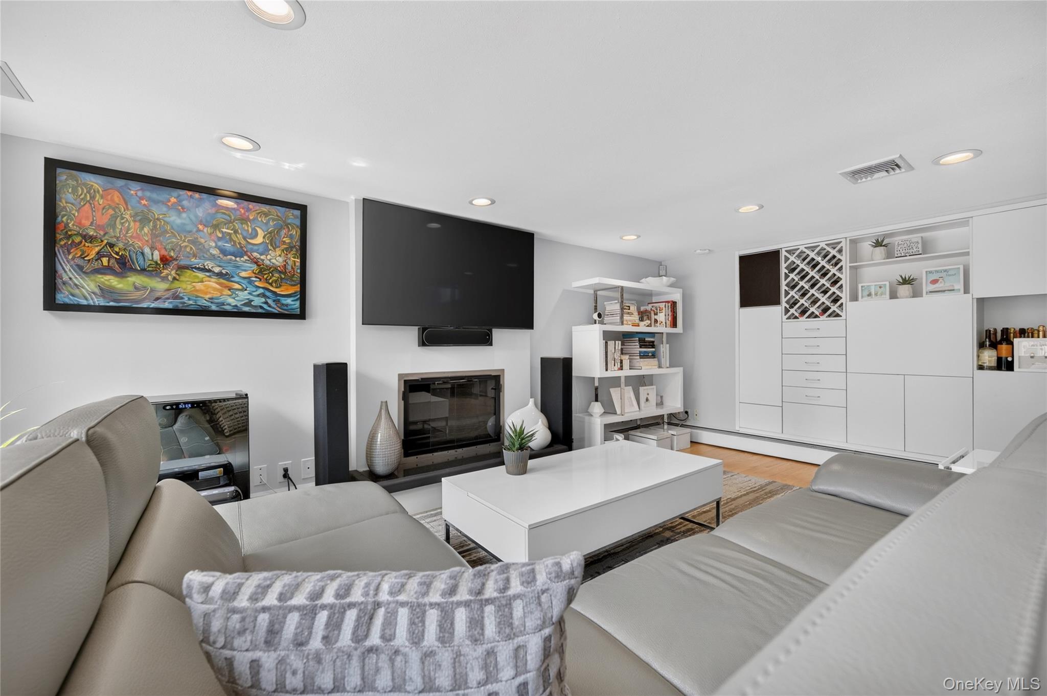 11 Sunbeam Road Syosset, NY 11791 - Photo 18 of 28 Living area featuring a fireplace with built-in white cabinetry with a wine rack