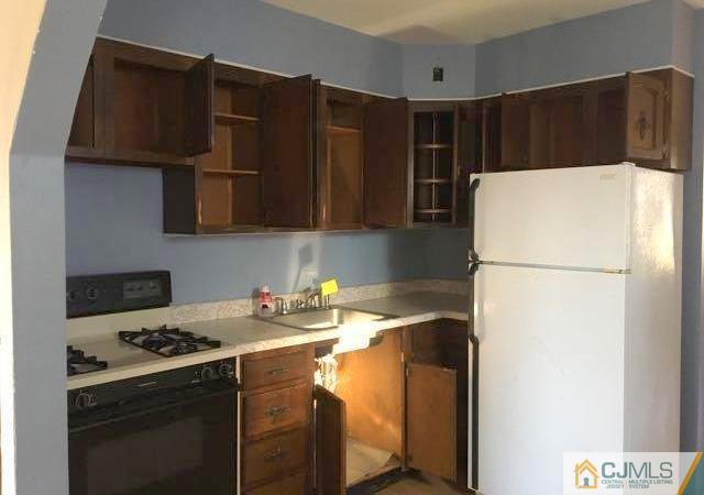 13 Sturgis Road Edison, NJ 08817 - Photo 11 of 22 a kitchen with a refrigerator and a stove top oven