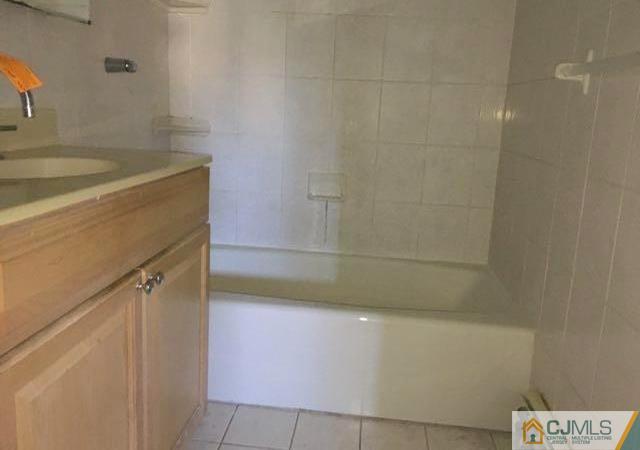 13 Sturgis Road Edison, NJ 08817 - Photo 12 of 22 a bathroom with a sink and washing machine