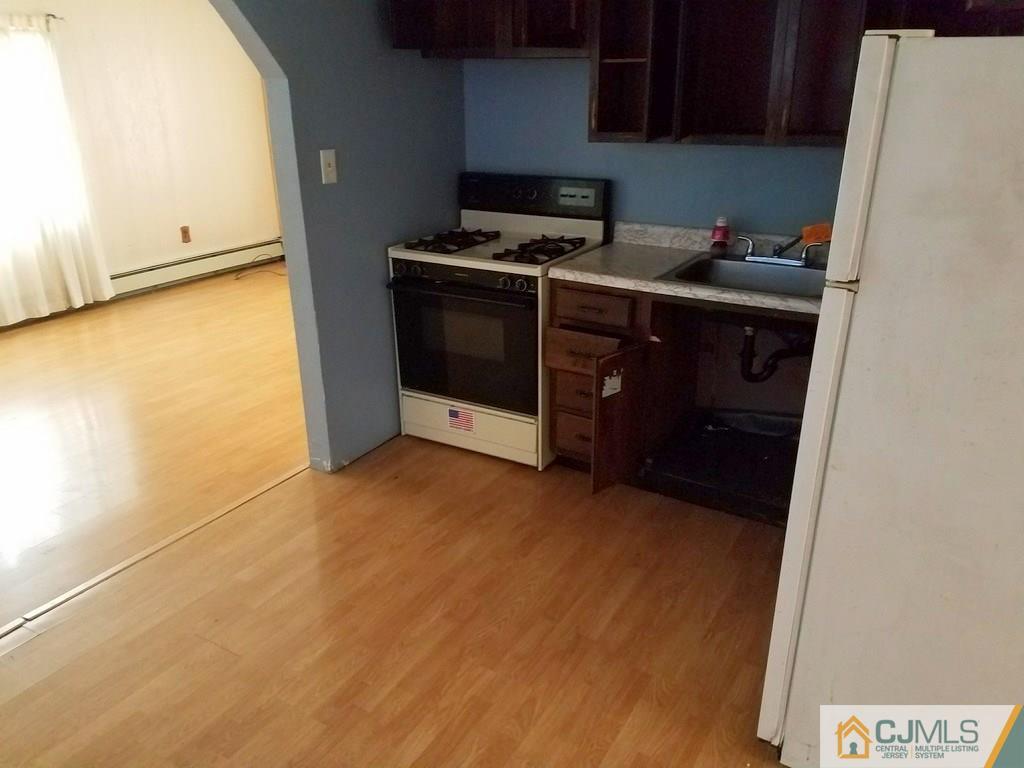 13 Sturgis Road Edison, NJ 08817 - Photo 16 of 22 a kitchen with a stove and a refrigerator