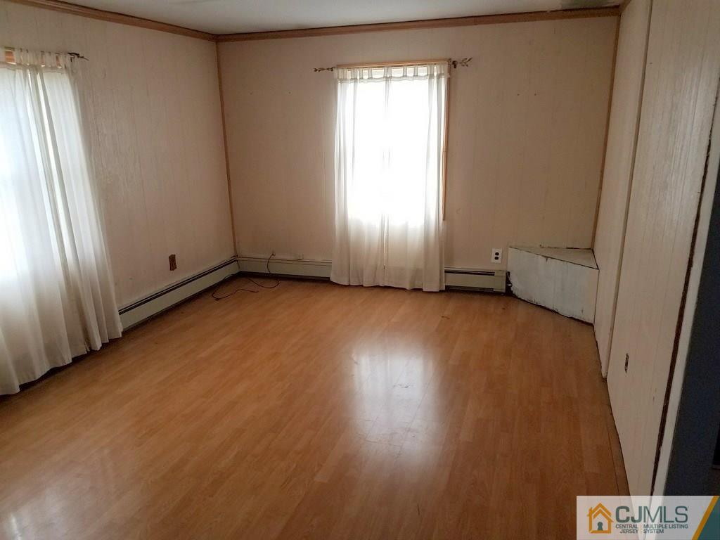 13 Sturgis Road Edison, NJ 08817 - Photo 18 of 22 an empty room with wooden floor and windows