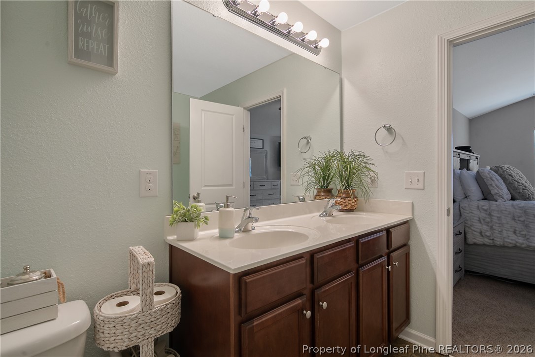 340 Battery Way Bunnlevel, NC 28323 - Photo 28 of 50 a bathroom with a sink and a mirror
