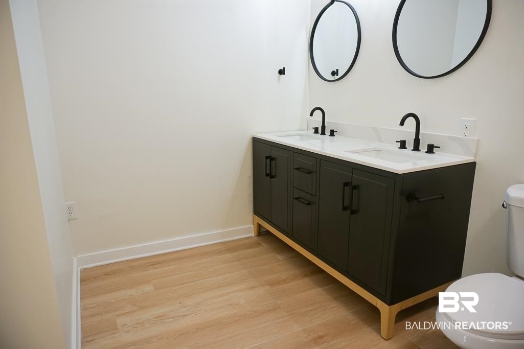 4667 Cottonwood Drive Mobile, AL 36608 - Photo 16 of 21 Bathroom with hardwood / wood-style floors, vanity, and toilet