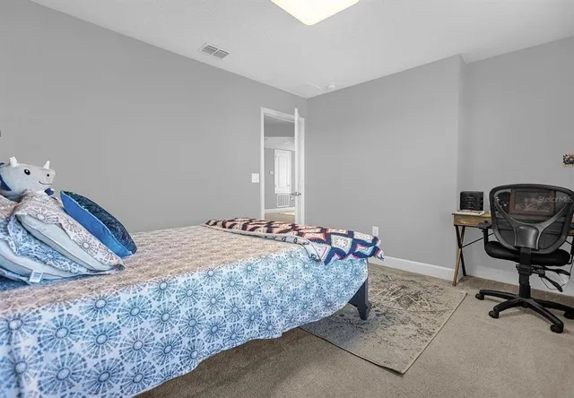 a bedroom with a bed and a workspace