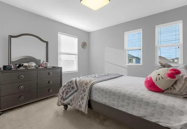 a bedroom with a bed and window