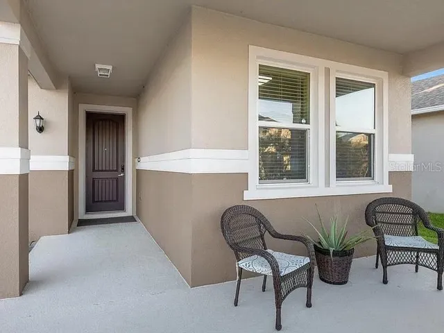 a living room with furniture and windows