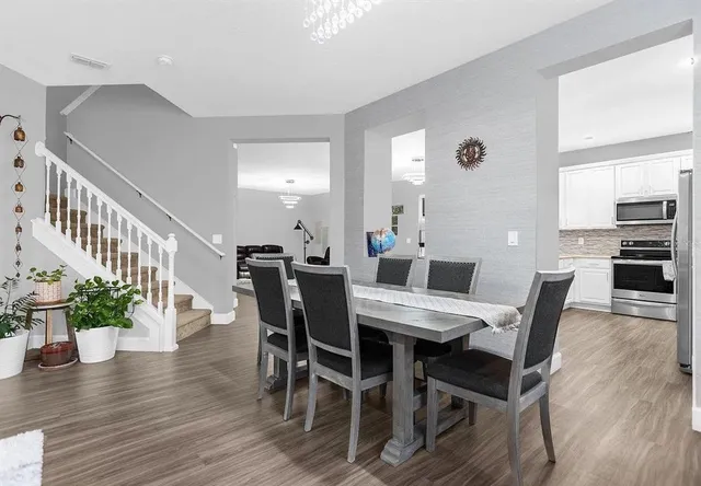 a view of a dining room with furniture and wooden floor