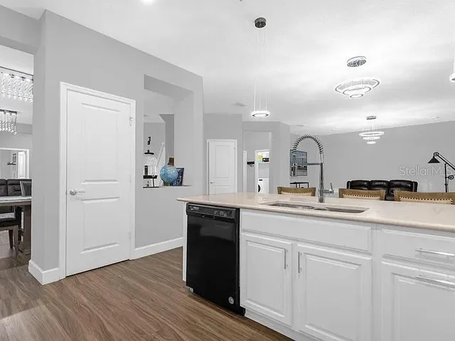 a kitchen with sink and cabinets