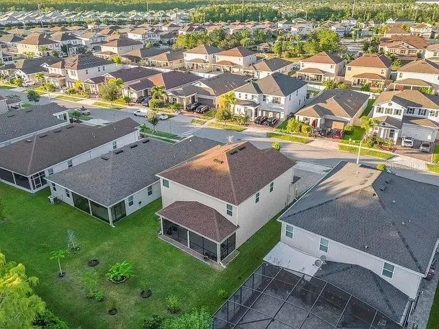 an aerial view of residential houses with outdoor space