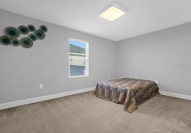 a room with a bed and a chandelier