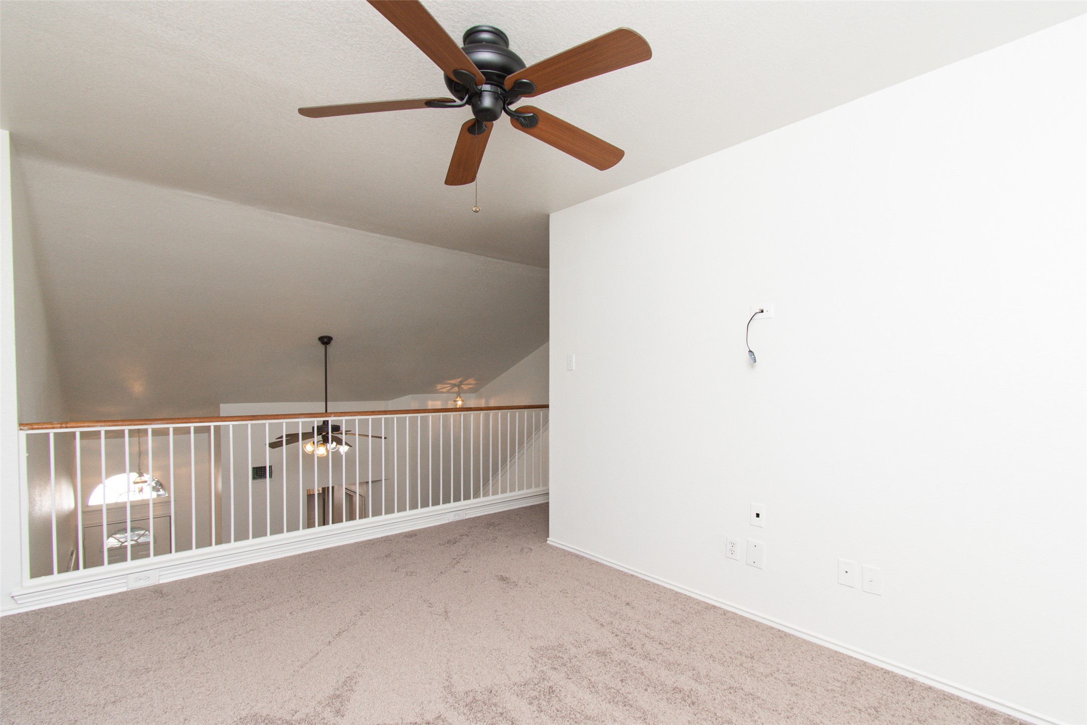 1436 Roxanne's Run Pflugerville, TX 78660 - Photo 16 of 24 An open loft space overlooks the level below through a classic railed balustrade.