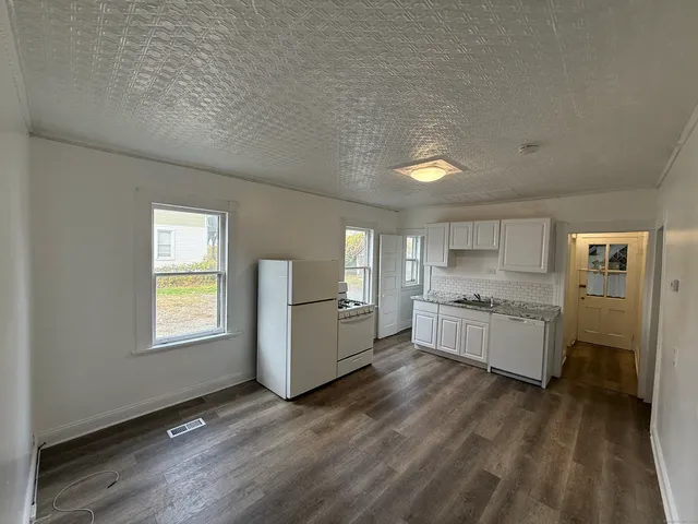 a kitchen with a refrigerator and a stove top oven