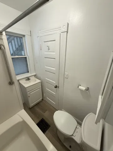a bathroom with a toilet a sink and mirror