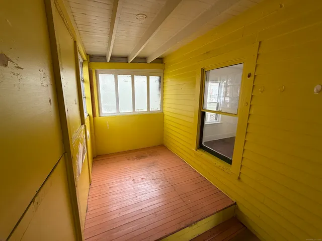 a view of hallway with wooden floor