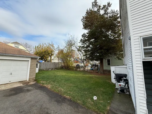 a view of a backyard with a garden and trees