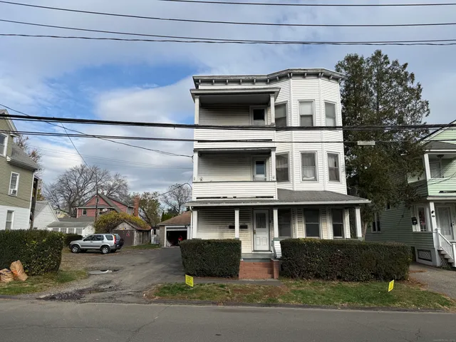 a front view of a building with parking space