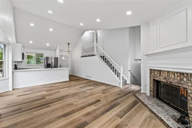 a view of kitchen and kitchen with fireplace wooden floor