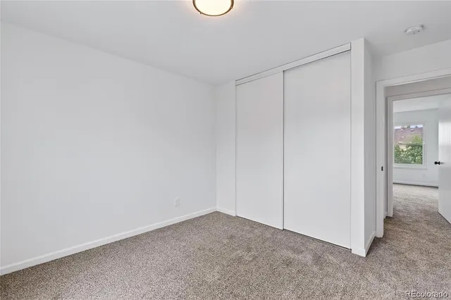 a view of an empty room and closet area
