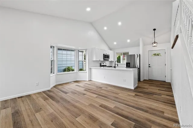 a view of kitchen with cabinets and wooden floor