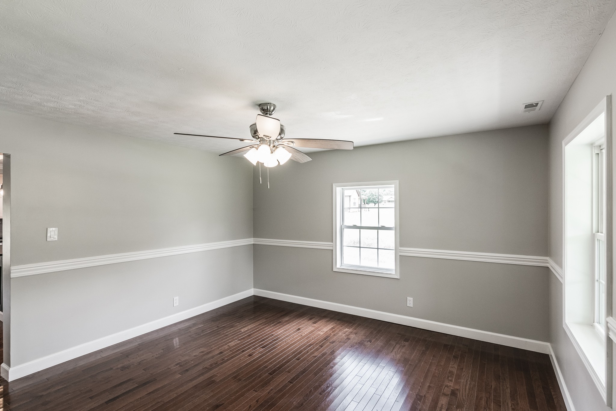 1267 Smiley Troutt Road Bethpage, TN 37022 - Photo 2 of 34 an empty room with wooden floor fan and windows