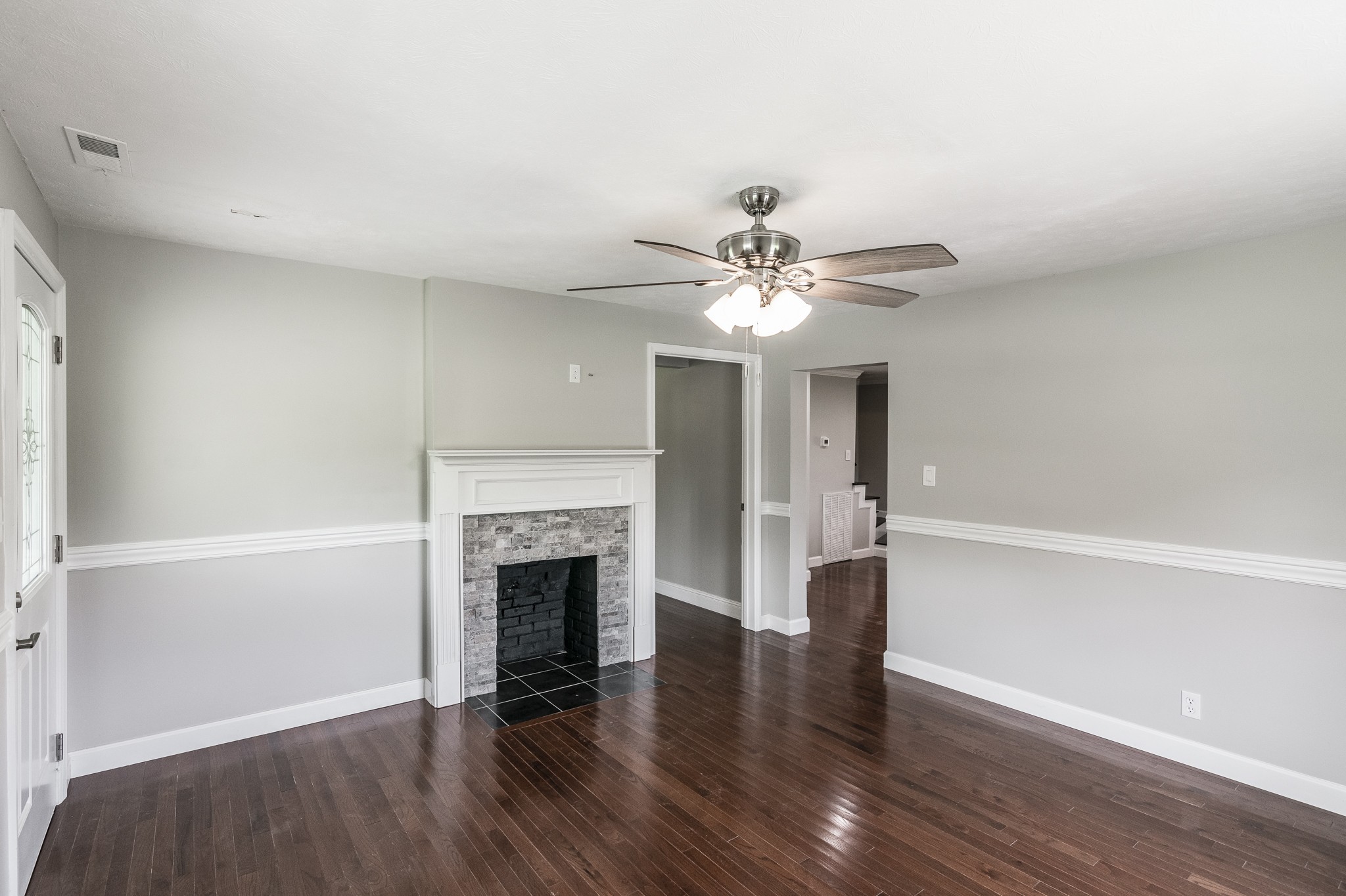 1267 Smiley Troutt Road Bethpage, TN 37022 - Photo 3 of 34 a view of an empty room with wooden floor and fireplace