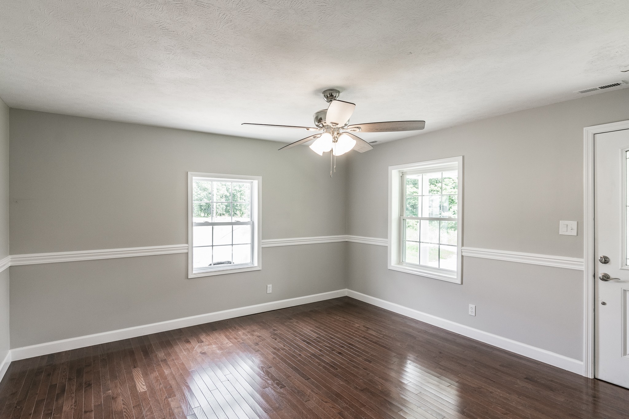 1267 Smiley Troutt Road Bethpage, TN 37022 - Photo 5 of 34 an empty room with wooden floor windows and fan