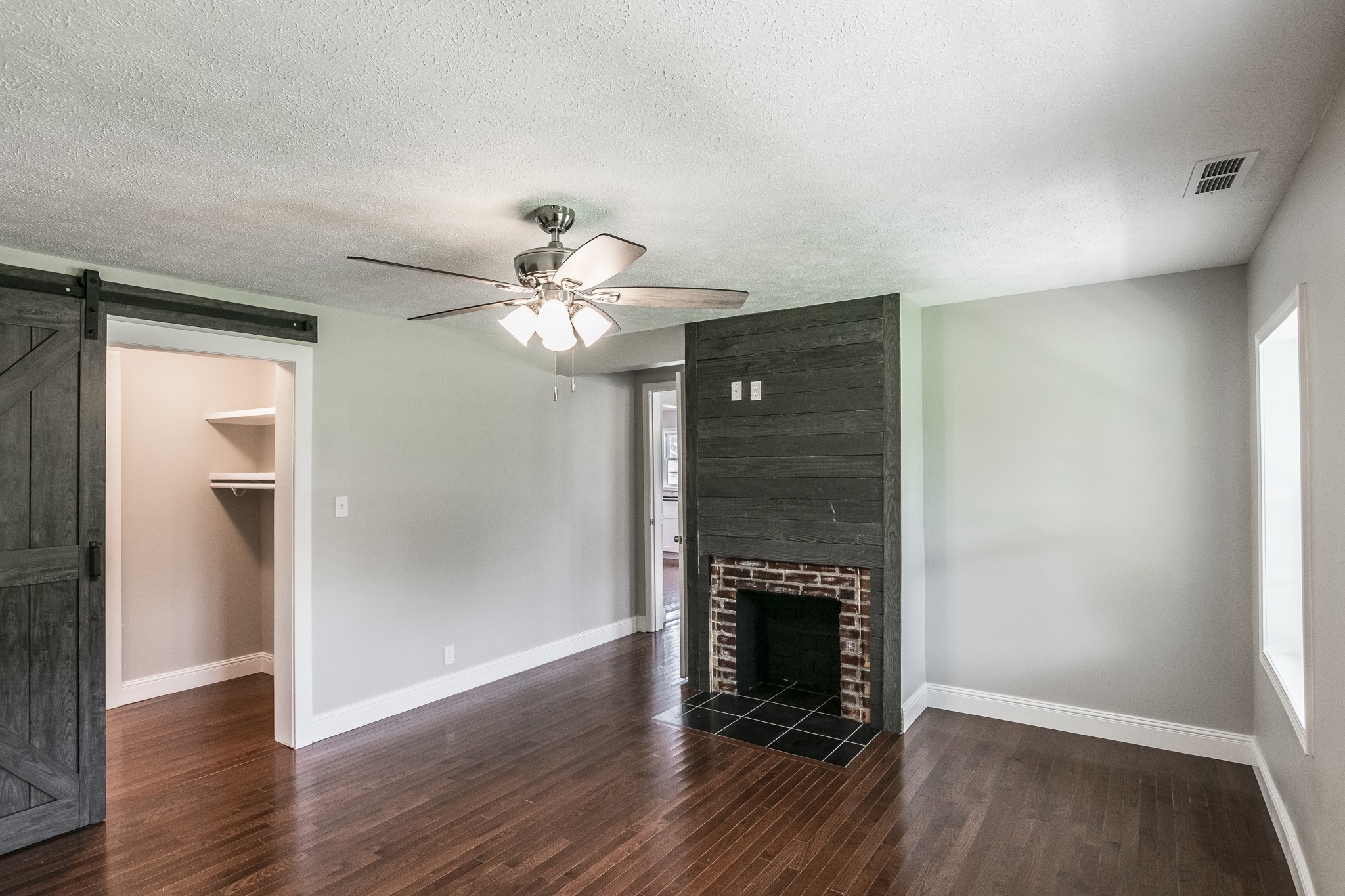 1267 Smiley Troutt Road Bethpage, TN 37022 - Photo 8 of 34 a view of an empty room with wooden floor and a fireplace