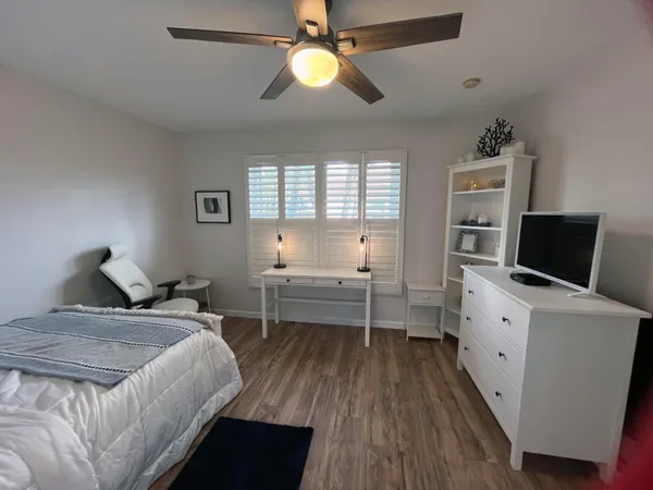 a bed room with a bed and a television