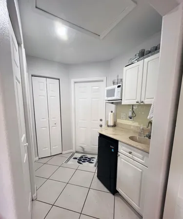 a kitchen that has a sink and a stove in it