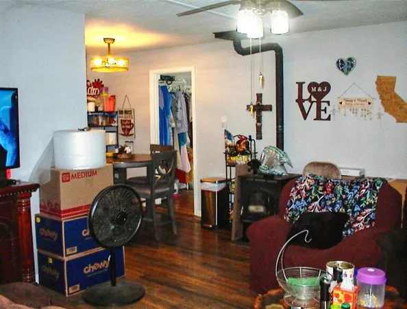 a living room with furniture and a chandelier