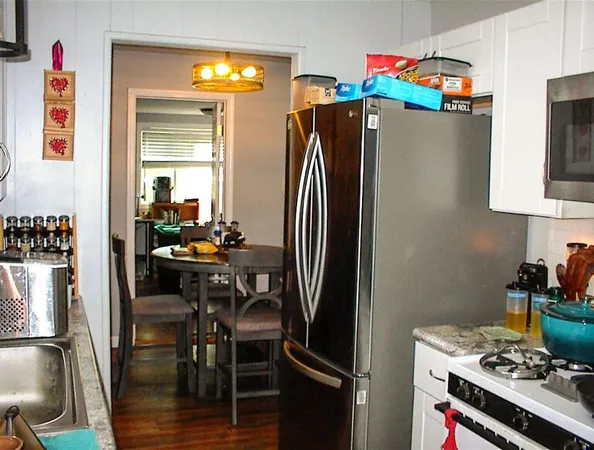a kitchen with stainless steel appliances a refrigerator and a stove top oven