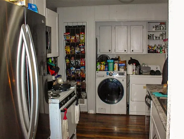 a kitchen with stainless steel appliances granite countertop a refrigerator a stove and a sink