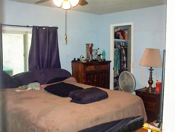 a bedroom with a bed and a lamp