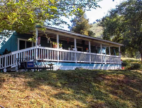 a view of a house with a yard and deck