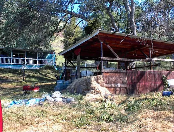 a view of a backyard with wooden fence