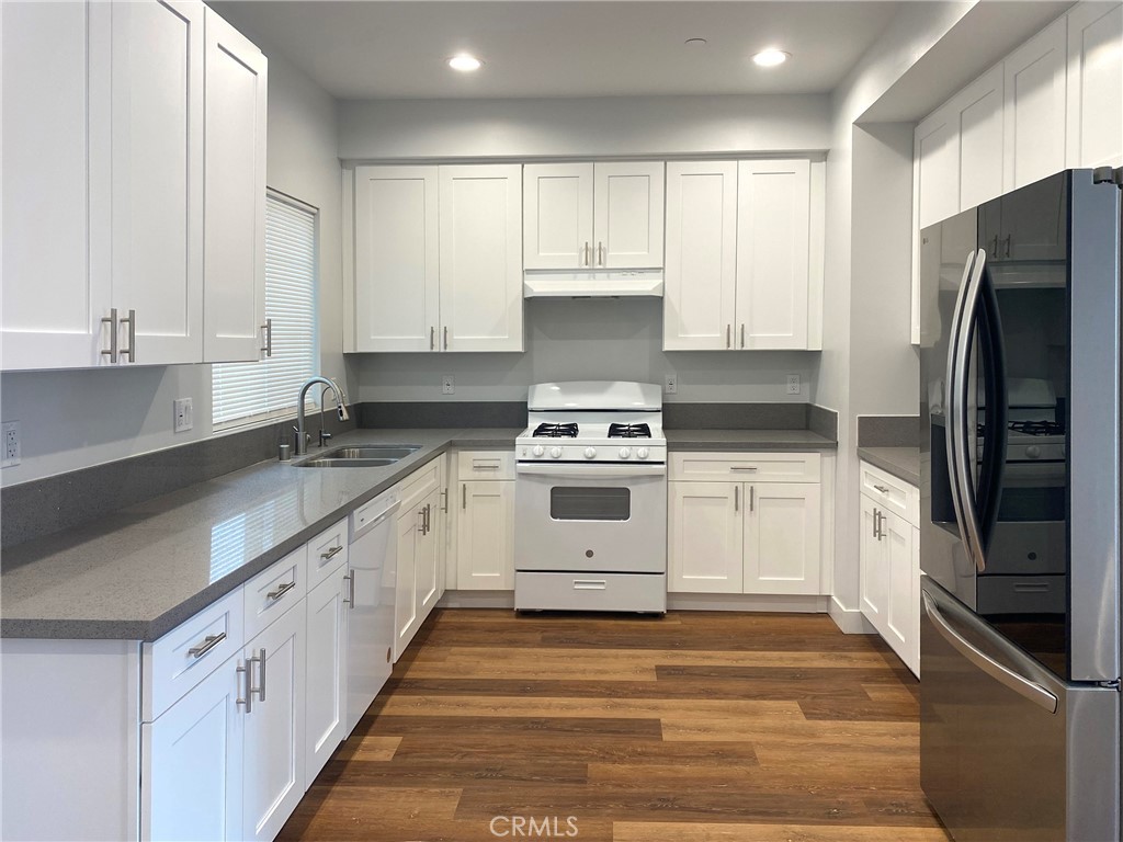 300 East Alhambra Road, Unit F Alhambra, CA 91801 - Photo 11 of 20 a kitchen with granite countertop white cabinets and stainless steel appliances
