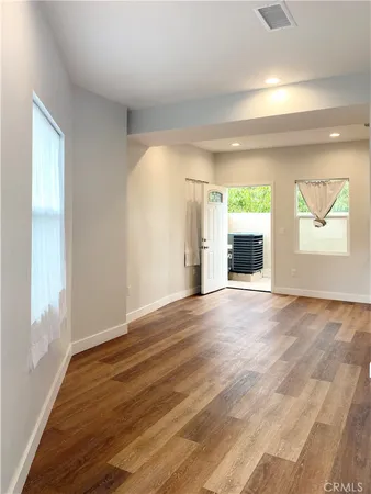 an empty room with windows and entrance