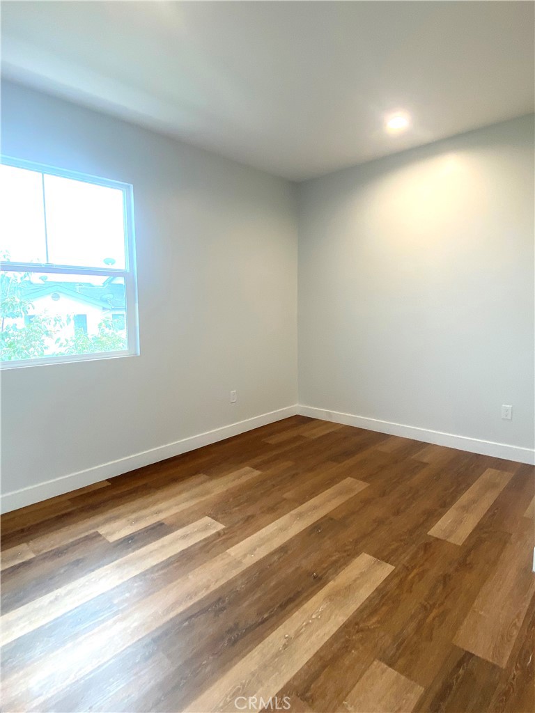 300 East Alhambra Road, Unit F Alhambra, CA 91801 - Photo 8 of 20 an empty room with wooden floor and windows