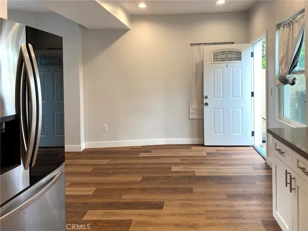 a view of a kitchen with a sink and a refrigerator