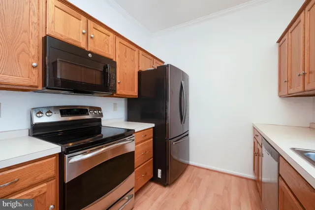 a kitchen with stainless steel appliances a stove microwave and sink