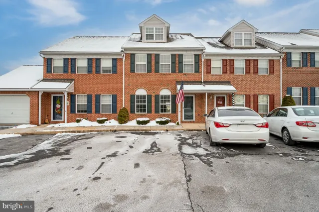 a front view of a residential apartment building with a yard
