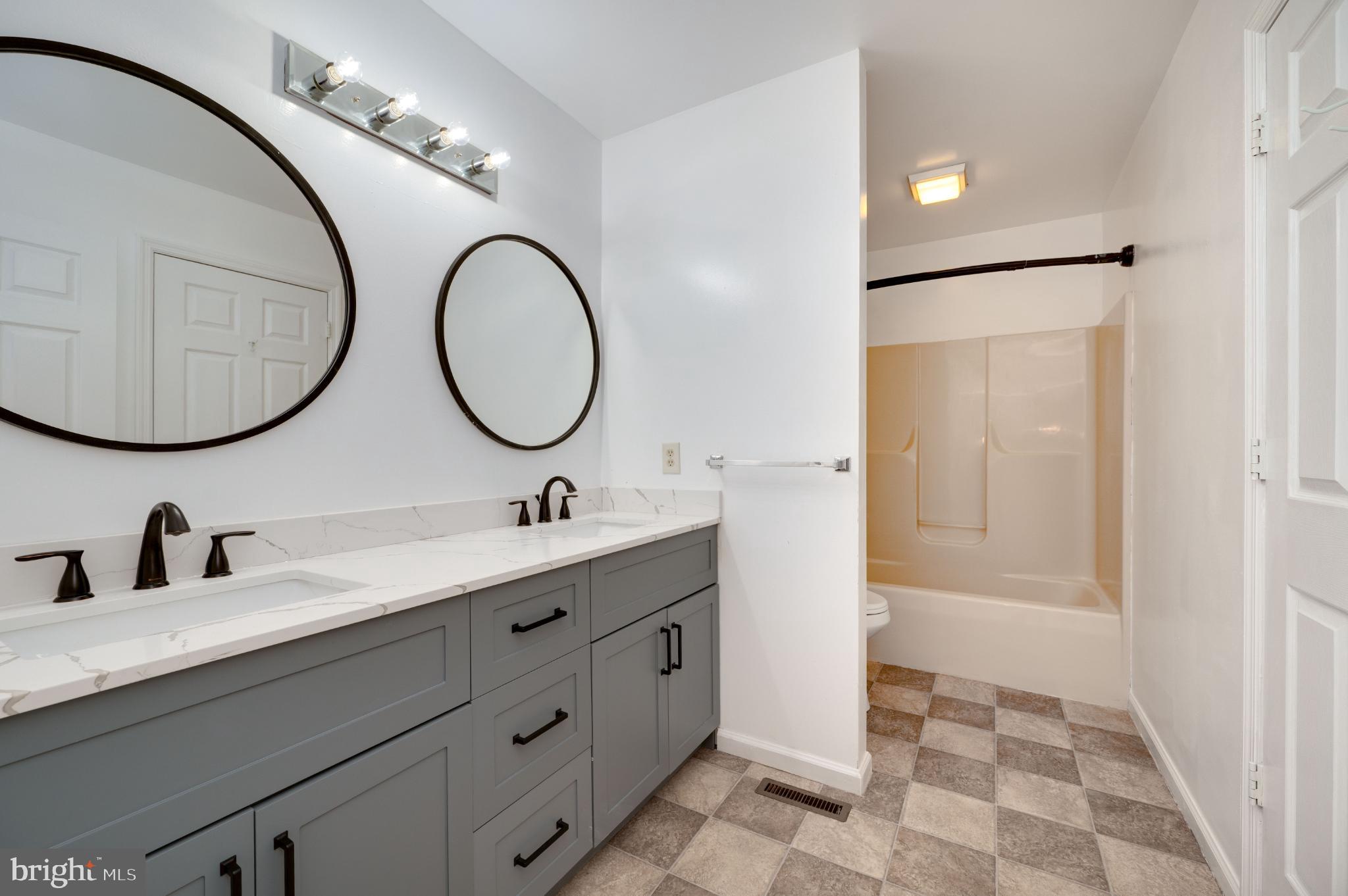 10 Chesterwood Circle Reading, PA 19607 - Photo 24 of 40 a bathroom with a double vanity sink and a mirror