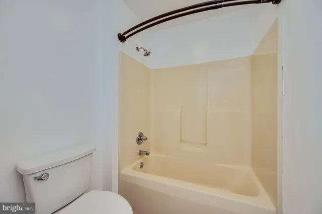 a bathroom with a bathtub and a toilet
