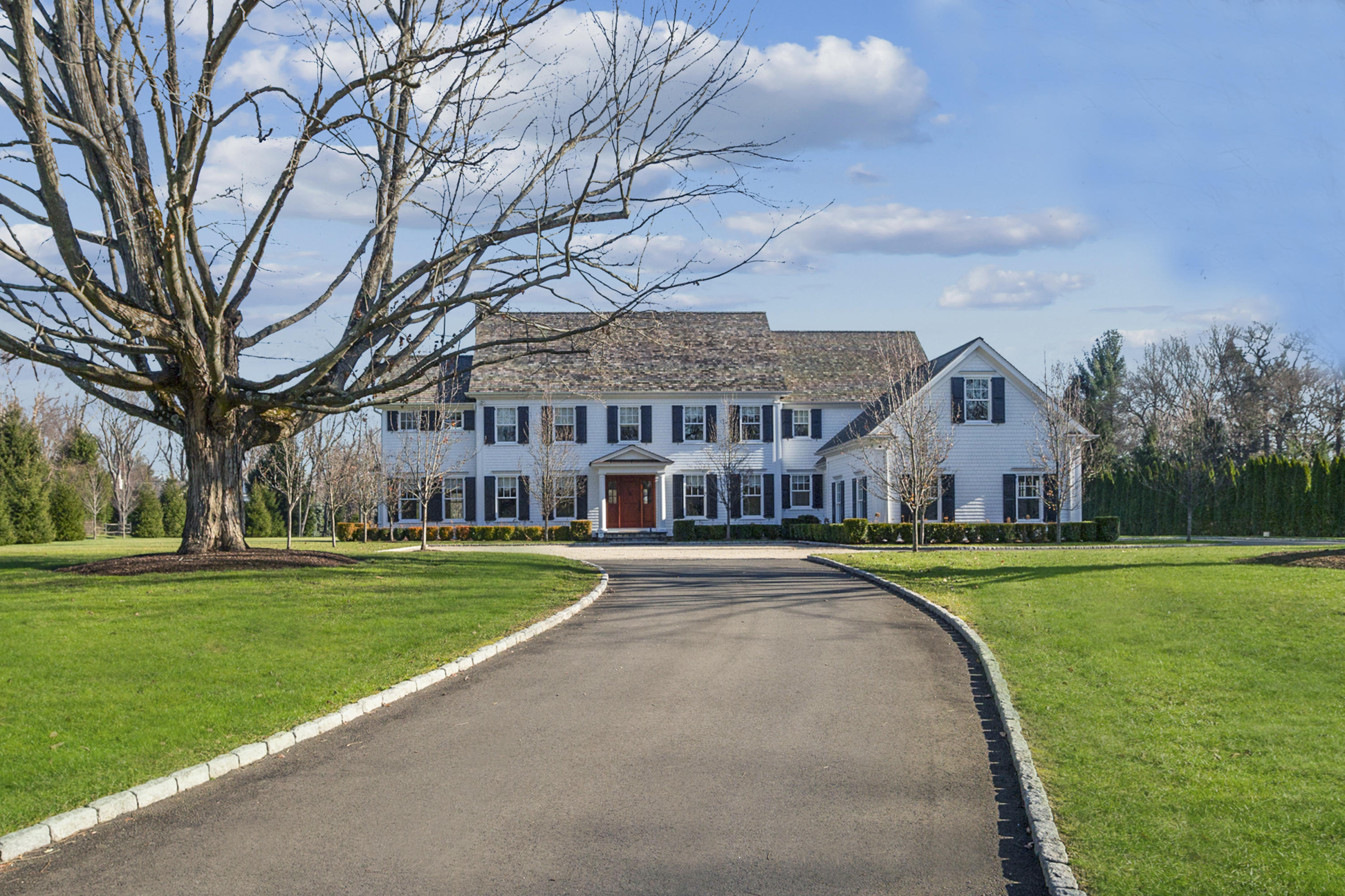 366 Brookside Road Darien, CT 06820 - Photo 1 of 40 a view of a big house with a big yard and large trees