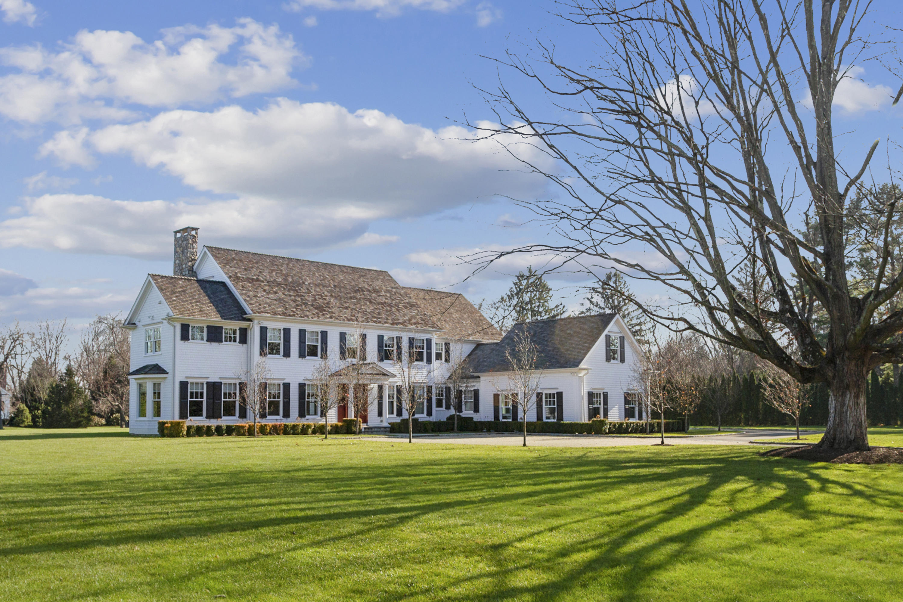 366 Brookside Road Darien, CT 06820 - Photo 2 of 40 a view of a big house with a big yard and large trees